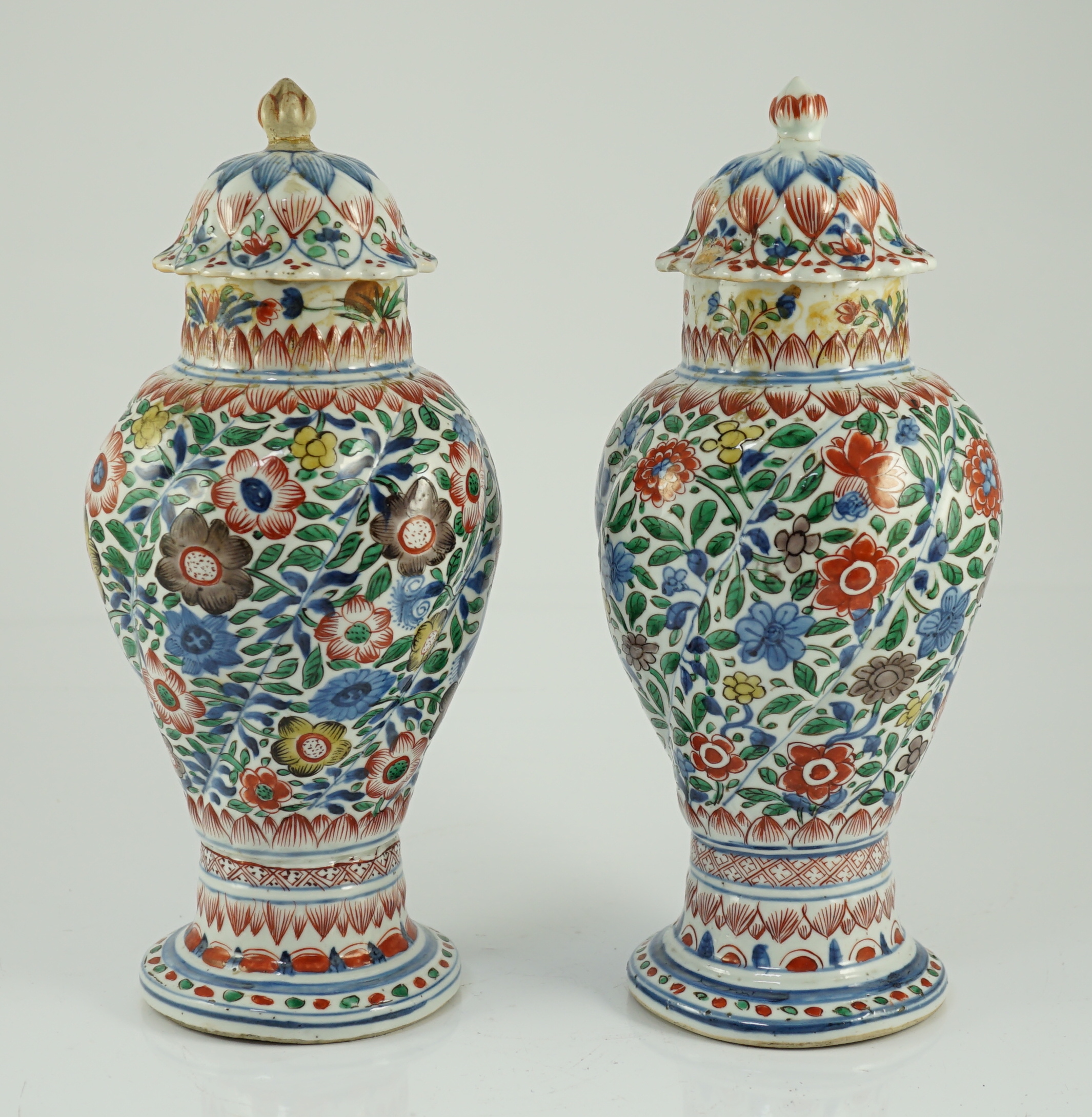 A pair of Chinese wucai spiral lobed baluster vases and covers, Kangxi, c.1680